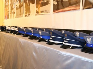 Policyjne czapki galowe ułożone na stole