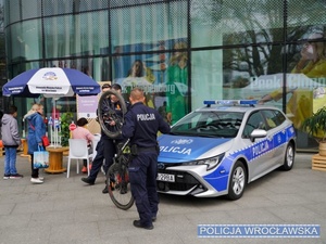 Funkcjonariusze Policji pod jedną z wrocławskich galerii handlowych w trakcie znakowania rowerów