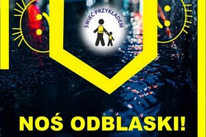 Grafika przedstawia idące dwie osoby oraz napis świeć przykładem, noś odblaski