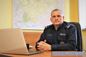 Naczelnik Wydziału Sztab Policji KMP we Wrocławiu siedzący za biurkiem